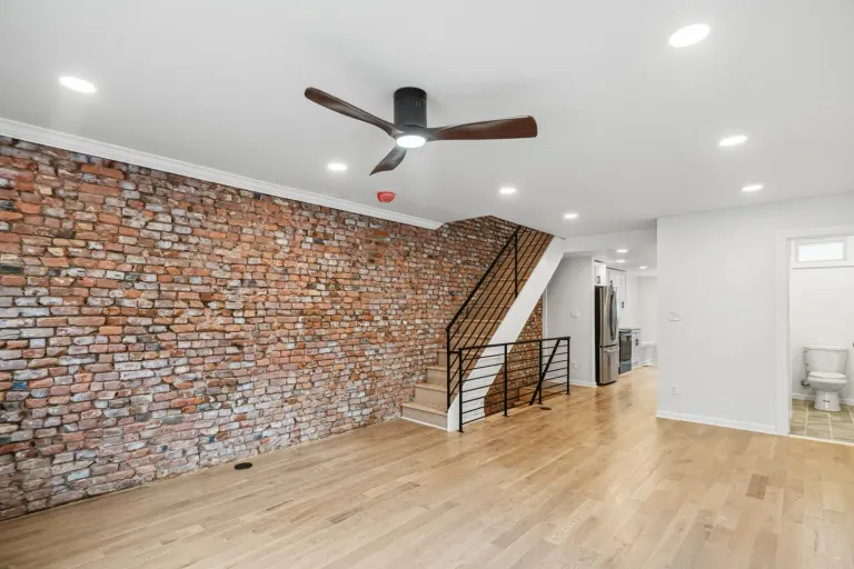 The exposed brick wall and open living space