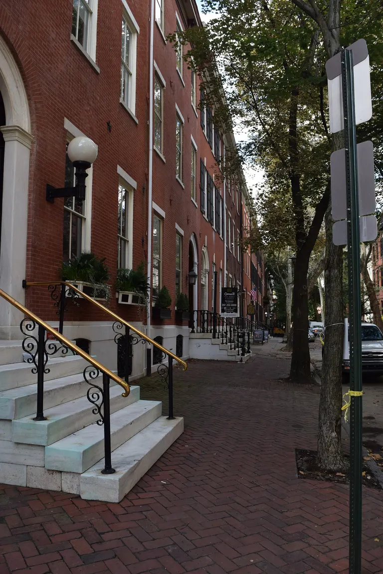 Philadelphia brick rowhouses, stone stoops and mature street trees; regional context only.