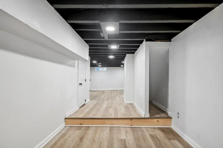 The basement with exposed dark ceiling