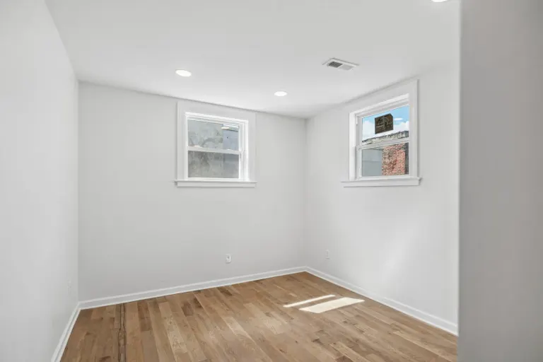 A finished room with two windows