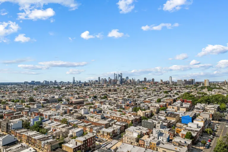 Aerial listing photograph across the Philadelphia neighborhood toward the skyline.