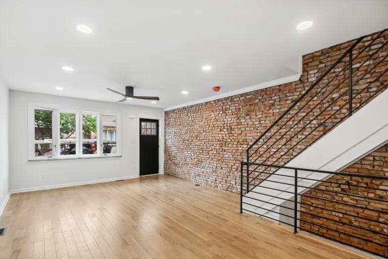 1842 South Fourth Street: completed living room, exposed brick and stairs.
